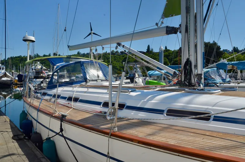 Footloose Yacht Photos Pics 2003 Bavaria 49 sailboat docked at marina, featuring sleek design and spacious deck.