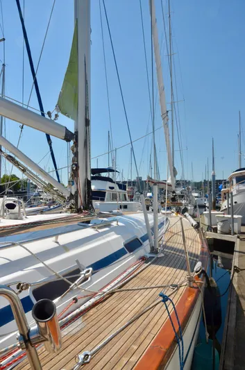 Footloose Yacht Photos Pics 2003 Bavaria 49 sailboat docked at a marina under clear blue skies.