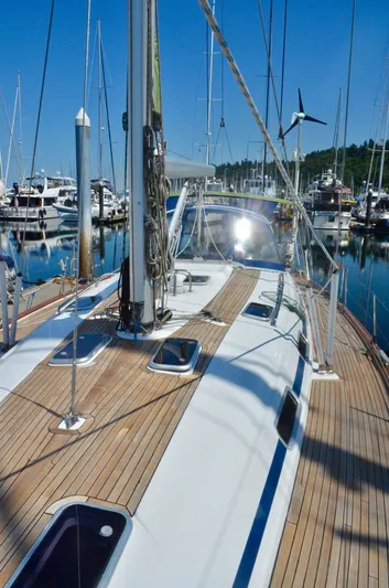 Footloose Yacht Photos Pics 2003 Bavaria 49 sailboat docked in marina, showcasing sleek deck and clear blue sky.