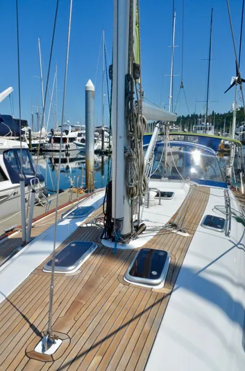 Footloose Yacht Photos Pics 2003 Bavaria 49 sailboat deck with marina view, featuring wooden finish and rigging.