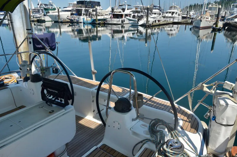 Footloose Yacht Photos Pics Cockpit view of 2003 Bavaria 49 sailboat docked in a marina.