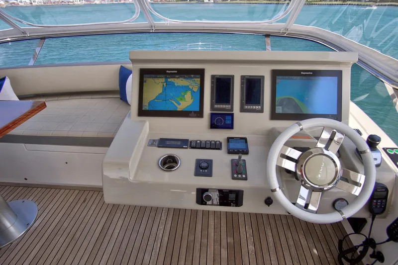 Gratitude Yacht Photos Pics 2017 Azimut 72 Flybridge helm with navigation screens and steering wheel, overlooking the ocean.
