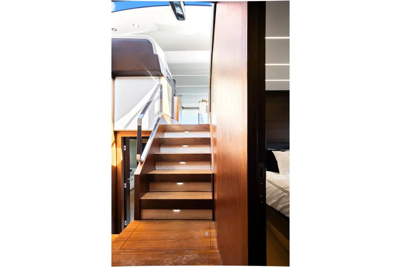 Gratitude Yacht Photos Pics Interior staircase of 2017 Azimut 72 Flybridge yacht, featuring sleek wooden design.