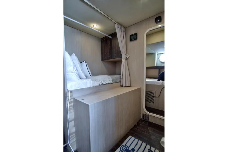 Gratitude Yacht Photos Pics Interior cabin of 2017 Azimut 72 Flybridge yacht, featuring cozy bedding and modern design.