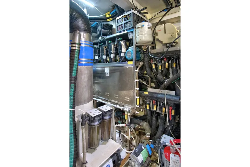 Gratitude Yacht Photos Pics Engine room of 2017 Azimut 72 Flybridge yacht, showcasing complex machinery and piping.