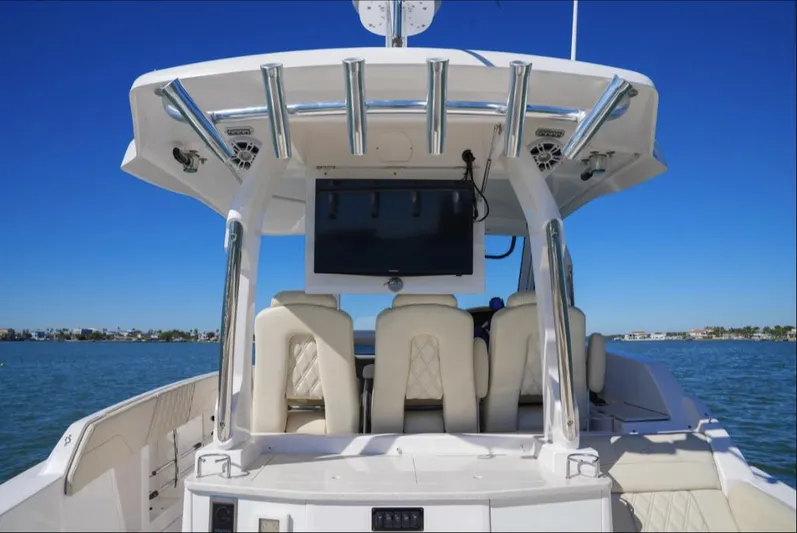  Yacht Photos Pics 2019 Regal 33 SAV boat interior with seating and TV, on a sunny day at sea.