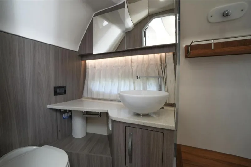  Yacht Photos Pics Luxurious bathroom in 2019 Regal 33 SAV boat with modern sink and wood accents.
