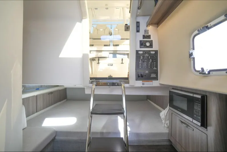  Yacht Photos Pics Interior of 2019 Regal 33 SAV boat with bed, microwave, and control panel.