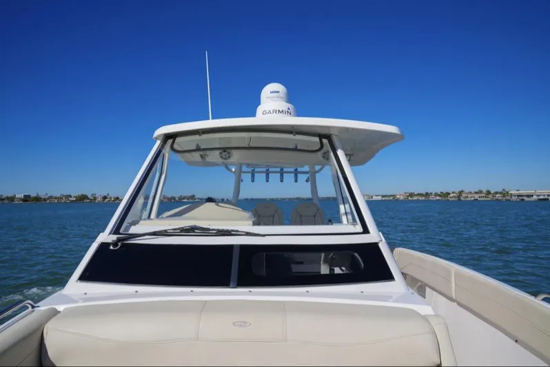  Yacht Photos Pics 2019 Regal 33 SAV boat on open water under clear blue sky.