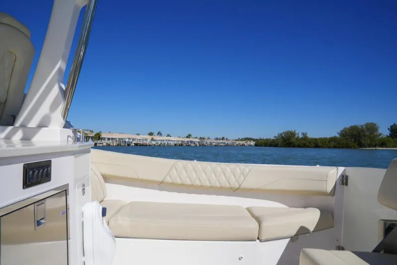  Yacht Photos Pics 2019 Regal 33 SAV boat interior with beige seating, overlooking serene blue waters.