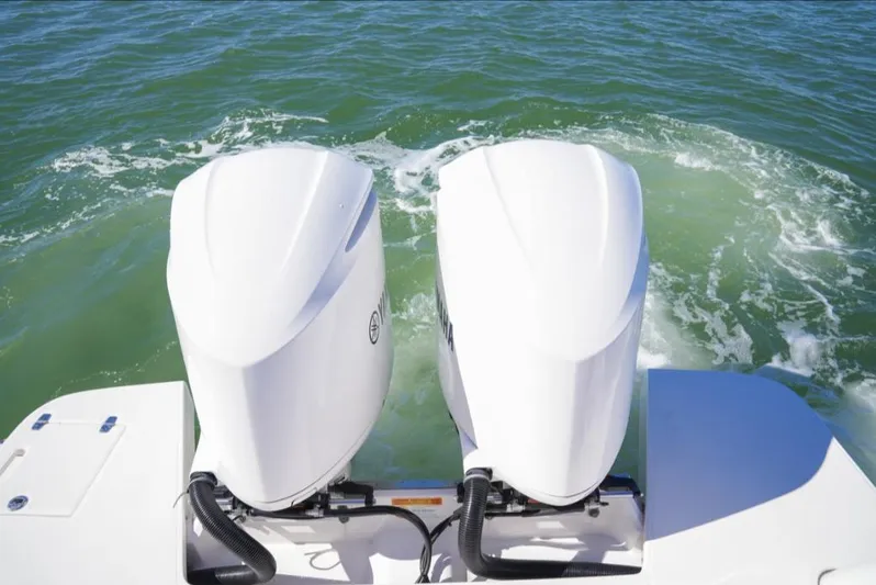  Yacht Photos Pics 2019 Regal 33 SAV boat with twin outboard engines on water.