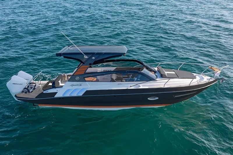 Ready For Delivery! Yacht Photos Pics 2025 Hanover 305 Outboard boat in black and orange on open water.