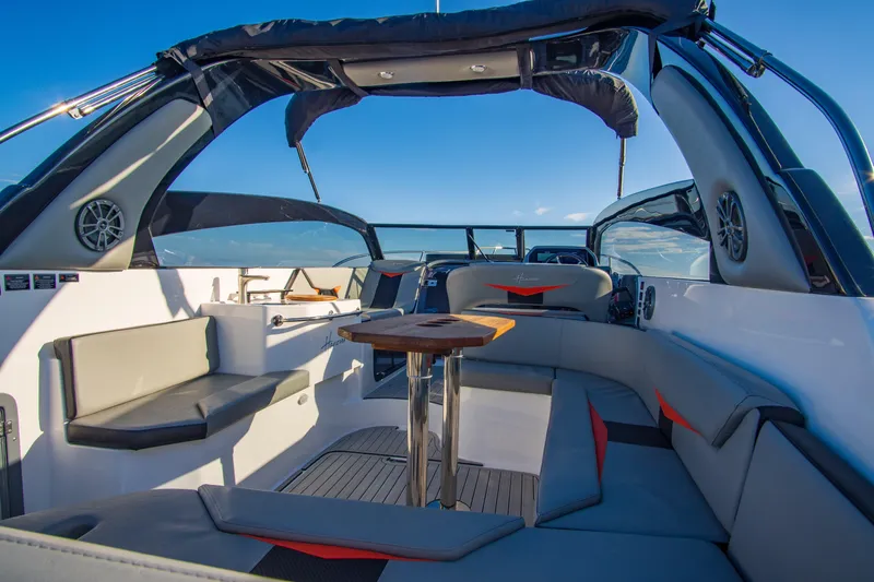 Ready For Delivery! Yacht Photos Pics Interior of 2025 Hanover 305 Outboard boat, featuring sleek black and orange design.