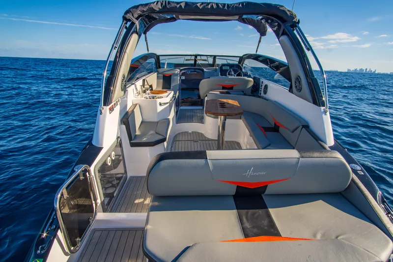 Ready For Delivery! Yacht Photos Pics 2025 Hanover 305 Outboard boat, black and orange, cruising on open sea.