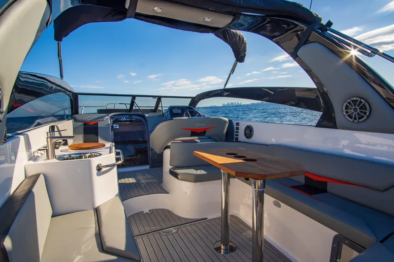 Ready For Delivery! Yacht Photos Pics Luxurious 2025 Hanover 305 Outboard boat interior, featuring sleek black and orange design.