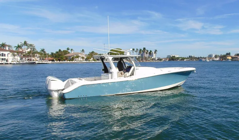  Yacht Photos Pics 2016 Edgewater 368 CC boat on calm water, clear sky, coastal background.