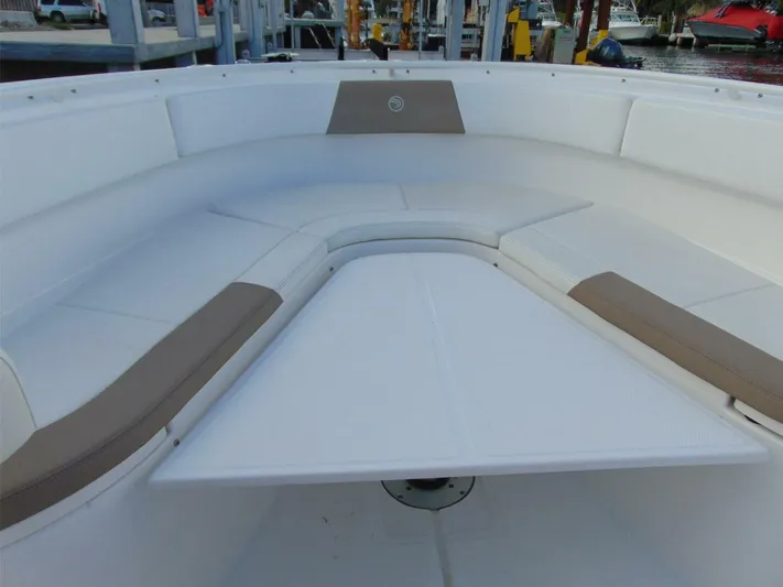  Yacht Photos Pics Edgewater 368 CC 2016 boat interior with cushioned seating and table.