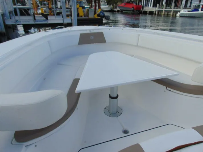  Yacht Photos Pics 2016 Edgewater 368 CC boat interior with seating and table, docked at marina.