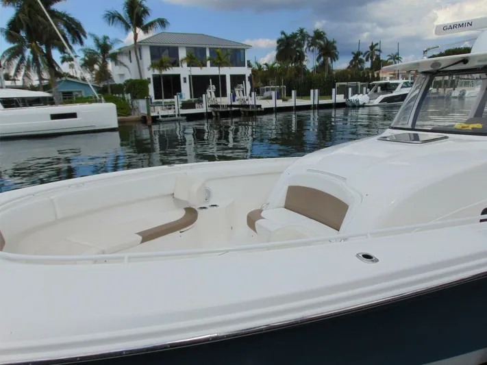  Yacht Photos Pics 2016 Edgewater 368 CC boat docked near waterfront homes, featuring spacious seating and sleek design.