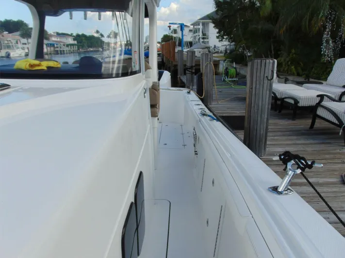  Yacht Photos Pics Edgewater 368 CC 2016 boat docked, showcasing sleek design and spacious deck area.