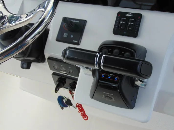  Yacht Photos Pics Control panel of 2016 Edgewater 368 CC boat with steering wheel and throttle.