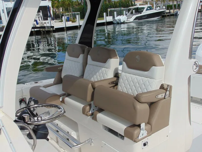  Yacht Photos Pics 2016 Edgewater 368 CC boat interior with luxurious seating and steering wheel.