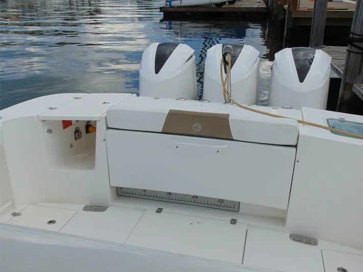  Yacht Photos Pics 2016 Edgewater 368 CC boat with triple outboard engines docked by the water.