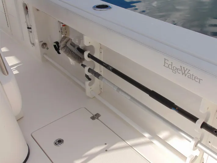  Yacht Photos Pics 2016 Edgewater 368 CC boat interior with fishing rod holder and storage compartment.