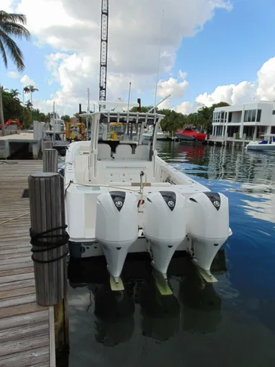  Yacht Photos Pics 2016 Edgewater 368 CC boat docked with triple outboard engines.