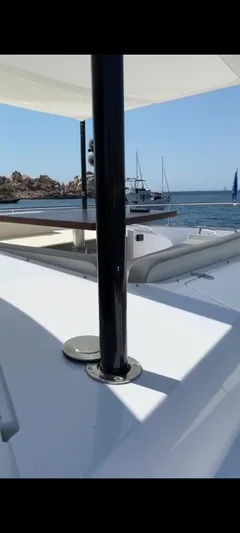  Yacht Photos Pics Azimut Magellano 66 yacht deck, 2019 model, with ocean view and sailboats in the background.