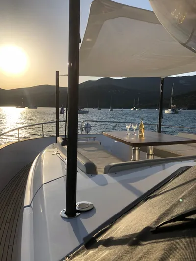  Yacht Photos Pics Azimut Magellano 66 yacht deck at sunset, 2019 model, with scenic ocean view.