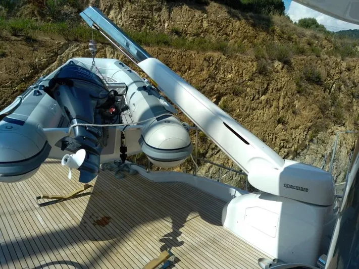  Yacht Photos Pics 2019 Azimut Magellano 66 yacht with a mounted inflatable boat on deck.