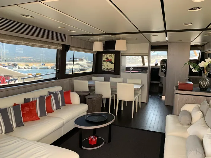  Yacht Photos Pics Luxurious interior of 2019 Azimut Magellano 66 yacht with modern furnishings and large windows.