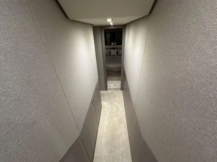  Yacht Photos Pics Narrow hallway inside 2019 Azimut Magellano 66 yacht, featuring modern design and lighting.