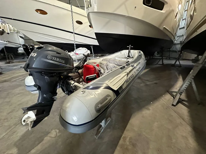  Yacht Photos Pics Inflatable boat with Yamaha motor beside Azimut Magellano 66 yacht in storage.