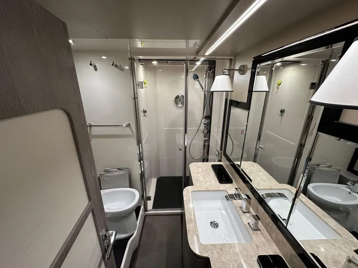  Yacht Photos Pics Luxurious bathroom in 2019 Azimut Magellano 66 yacht, featuring modern fixtures and elegant design.