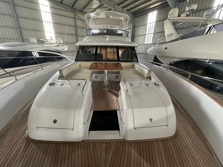  Yacht Photos Pics 2019 Azimut Magellano 66 yacht in a marina, showcasing spacious deck and seating area.