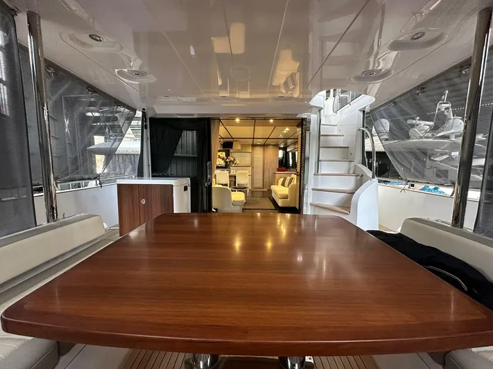  Yacht Photos Pics Luxurious interior of 2019 Azimut Magellano 66 yacht with elegant wooden table.