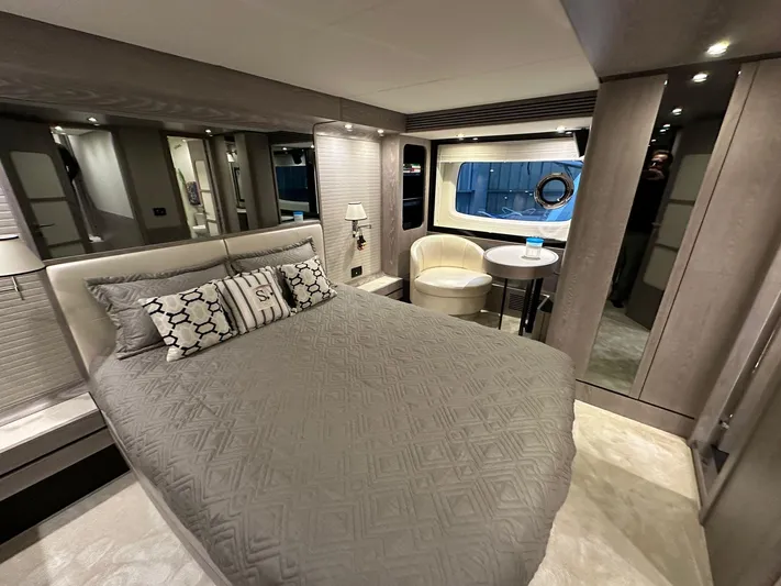  Yacht Photos Pics Luxurious bedroom interior of 2019 Azimut Magellano 66 yacht with elegant decor and large window.