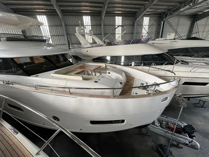  Yacht Photos Pics Azimut Magellano 66 yacht, 2019 model, docked in a spacious indoor marina.