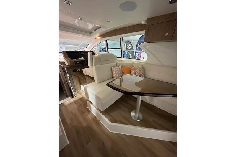  Yacht Photos Pics Luxurious interior of 2026 Cruisers Yachts 42 Cantius with elegant seating and wooden flooring.