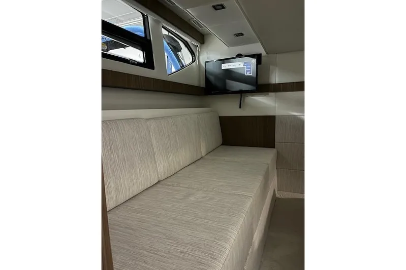  Yacht Photos Pics Interior of 2026 Cruisers Yachts 42 Cantius, featuring a cozy seating area and wall-mounted TV.