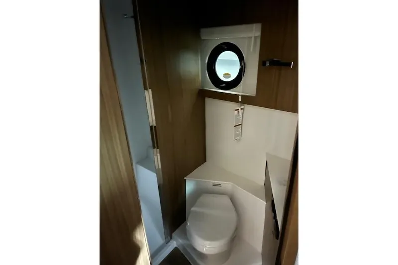  Yacht Photos Pics 2026 Cruisers Yachts 42 Cantius bathroom with modern design and porthole window.