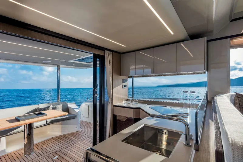  Yacht Photos Pics Luxurious interior of 2026 Absolute NAVETTA 48 yacht with ocean view and modern kitchen.