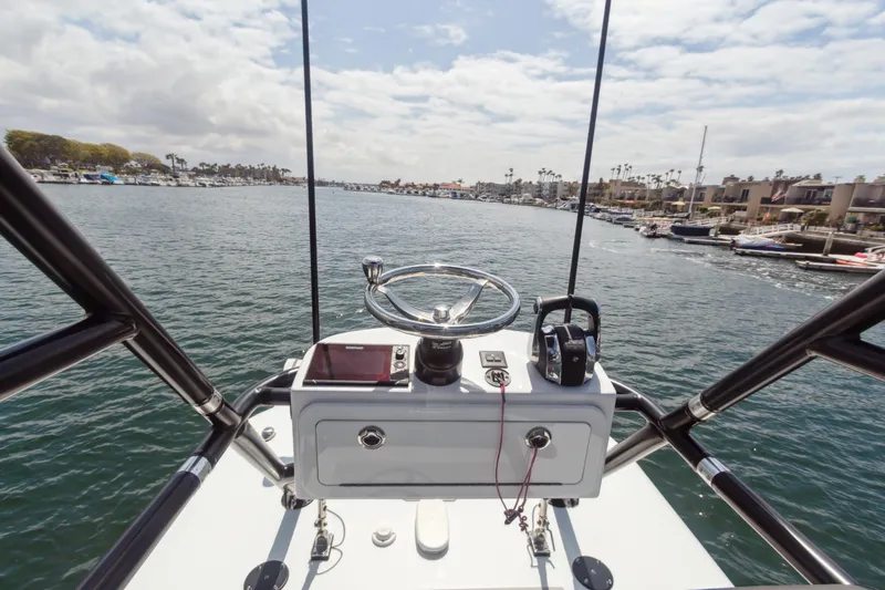 Bangarang Yacht Photos Pics Helm view of 2022 Freeman 34VH boat navigating a scenic coastal waterway.