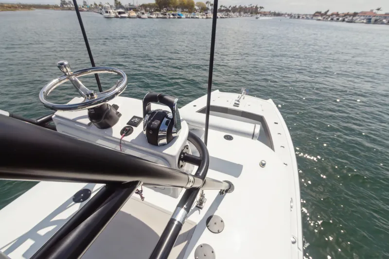 Bangarang Yacht Photos Pics 2022 Freeman 34VH boat on water, featuring steering wheel and controls, with marina in background.