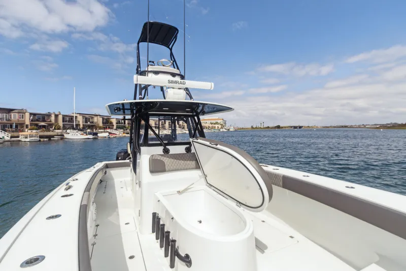Bangarang Yacht Photos Pics 2022 Freeman 34VH boat on water, open hatch, clear sky, waterfront homes in background.