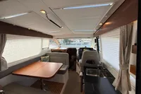 Interior of 2024 Nimbus 305 Coupe, featuring dining area and helm station.