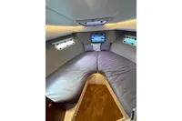 Luxurious interior cabin of 2024 Nimbus 305 Coupe with cozy bedding and TV.
