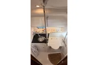 2024 Nimbus 305 Coupe bathroom with compact design, featuring sink, shower, and storage.